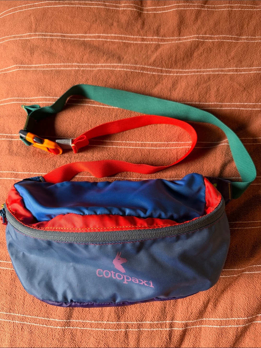 cotopaxi navy blue bag with red and teal straps